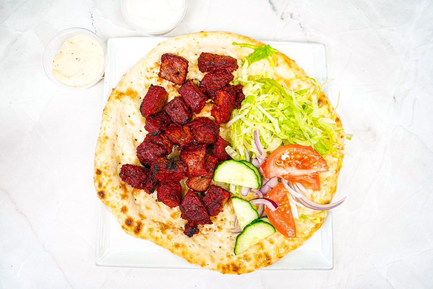 Lamb tikka kebab on naan